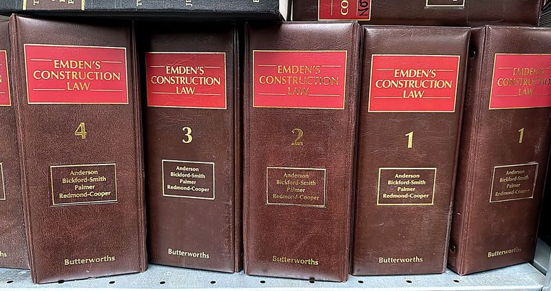 Five loose-leaf binders of Emden's Construction Law, published by Butterworths, on a shelf awaiting collection.